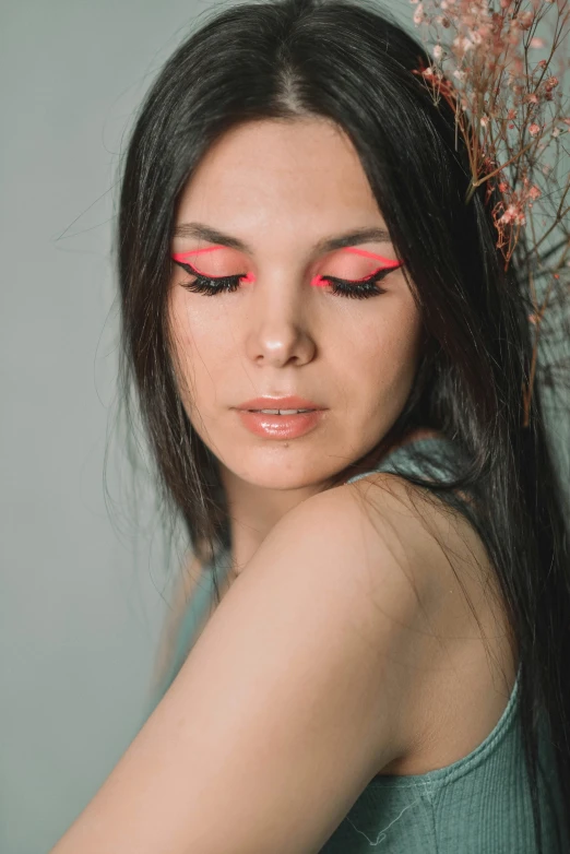 woman with long black hair wearing pink makeup