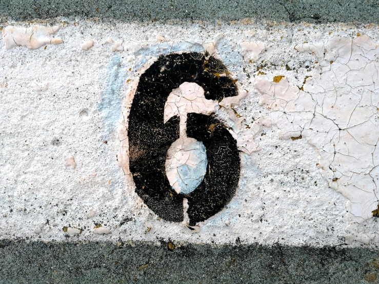 the number five is painted on the concrete surface