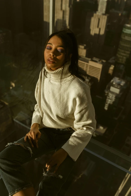 a woman sitting on top of a glass floor