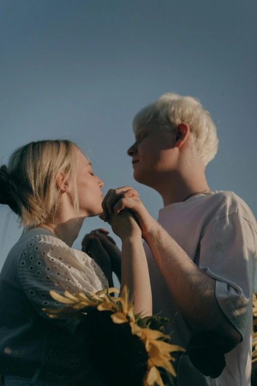 two people standing together holding hands