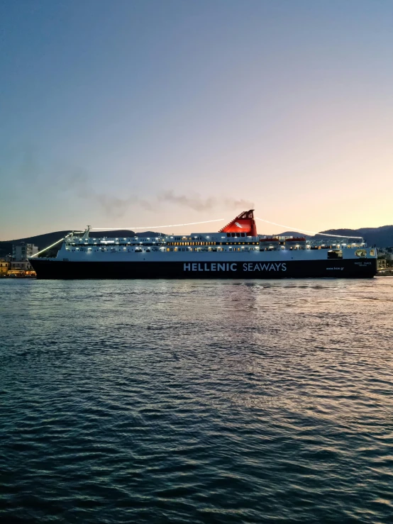 a cruise ship is parked at the side of a bay