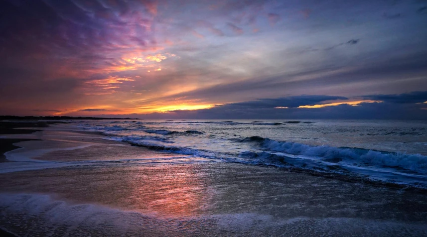 water coming out of the ocean in front of the sun