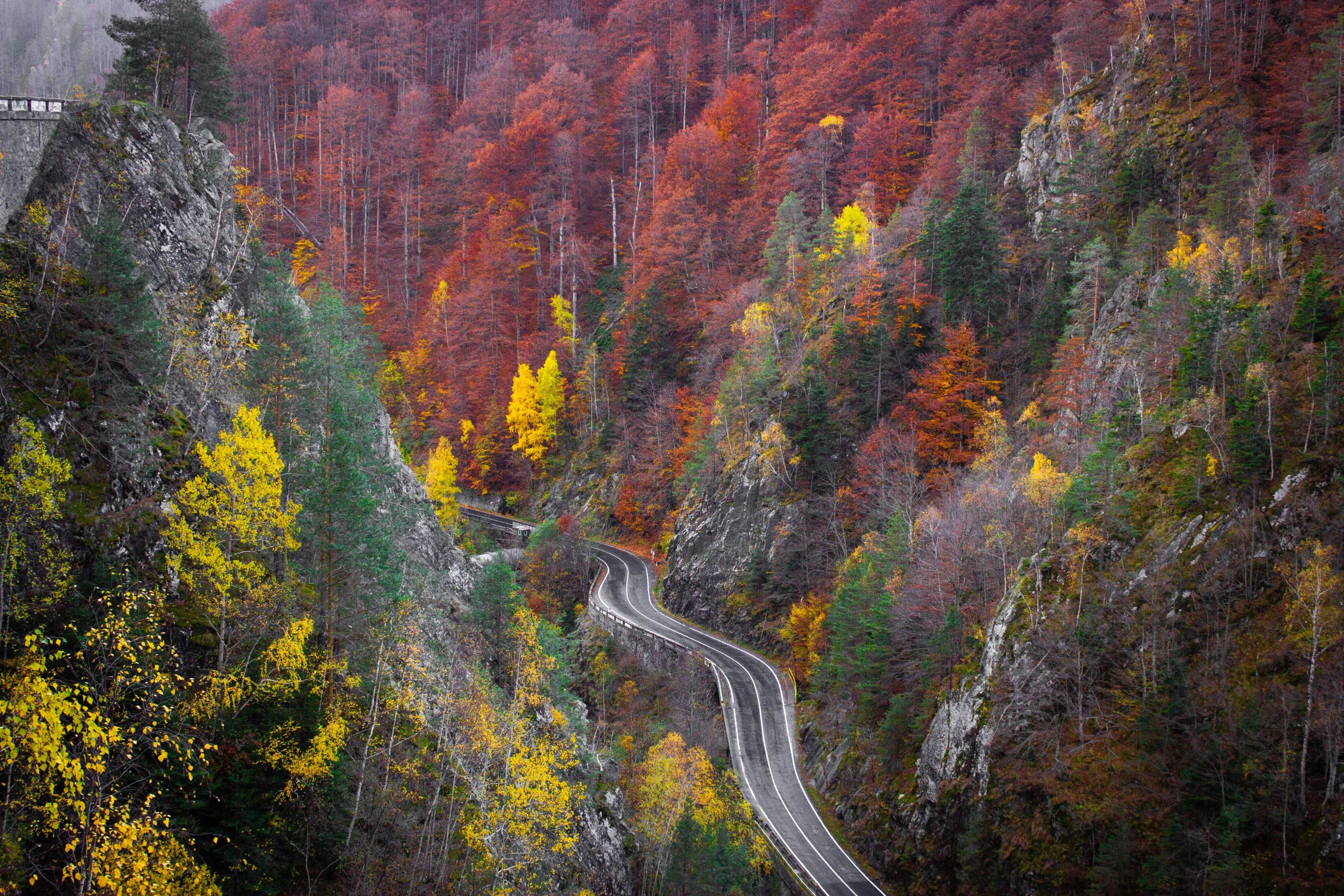 the road is winding down some steep mountain side