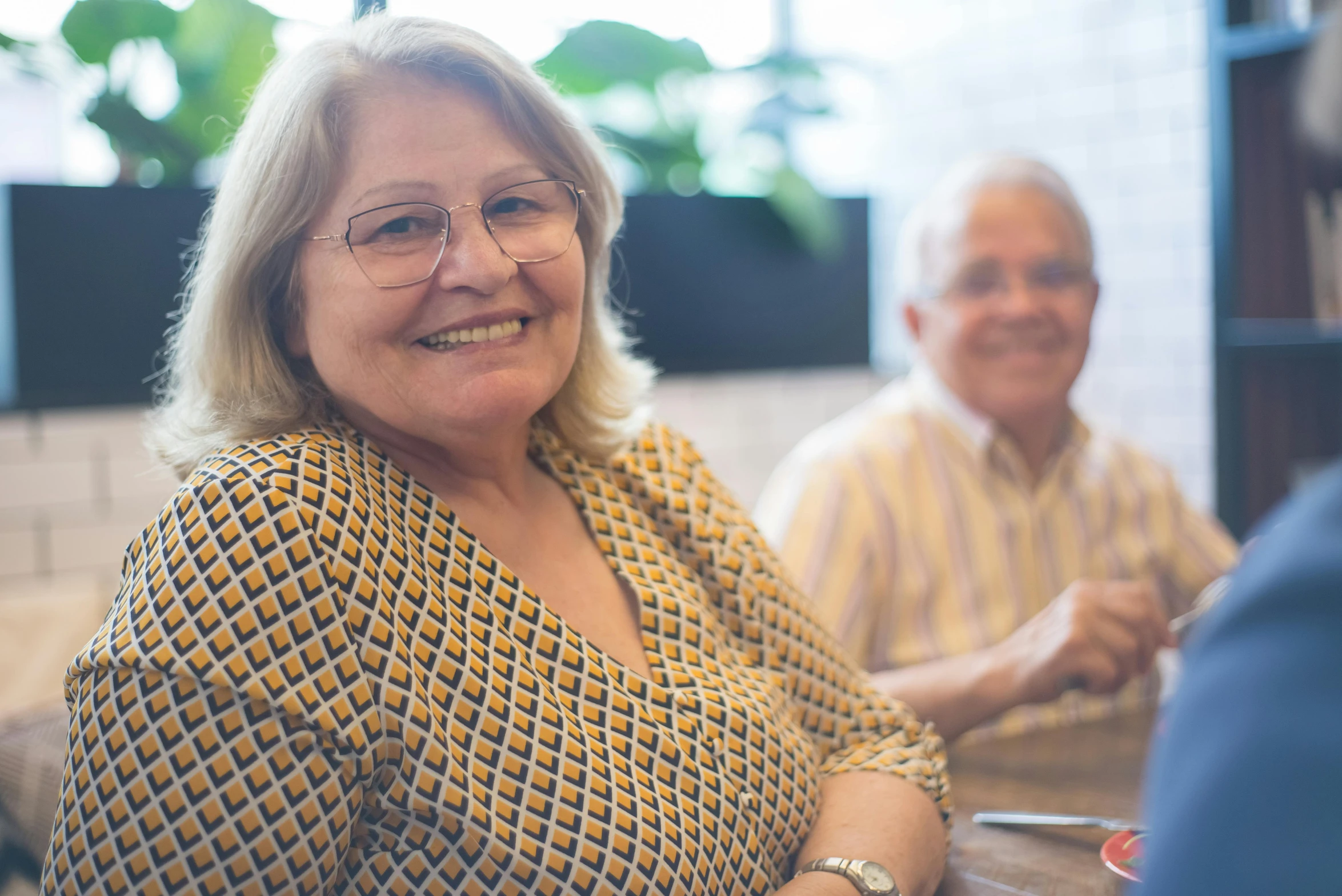 the smiling older couple is having an awkward conversation