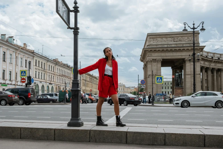 a woman standing on the edge of a city street