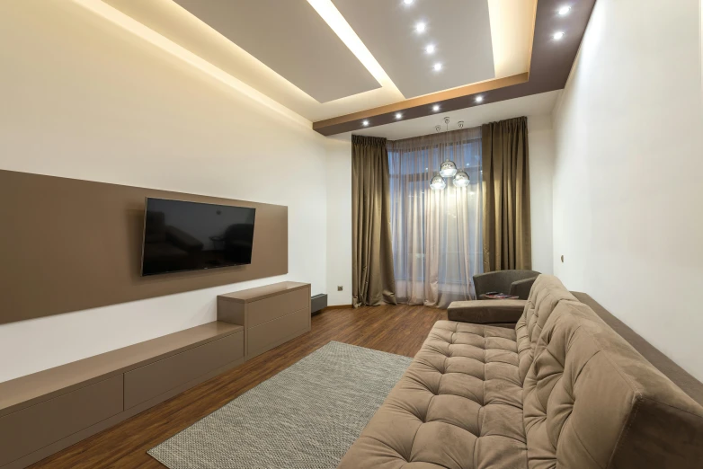 an empty living room with a large flat screen tv on the wall