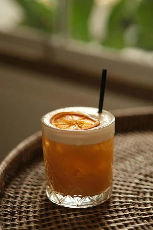 a small glass filled with soing on a table