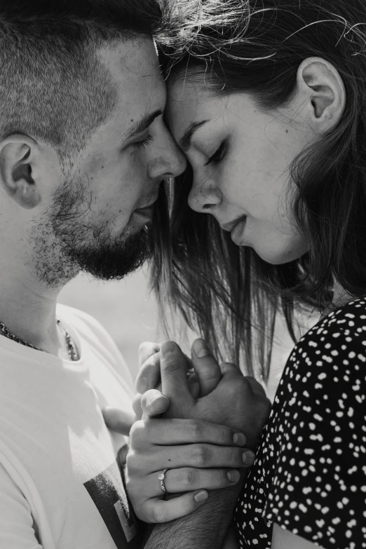 two people standing with their hands close together