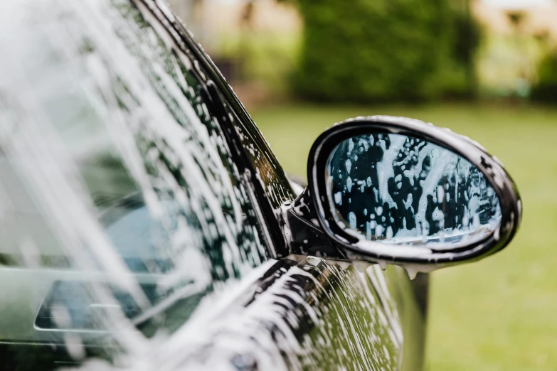 the side view mirror of a car reflecting its reflection