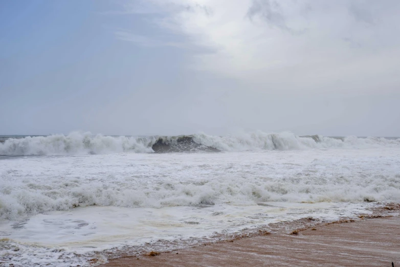 large white foamy waves rolling towards the beach