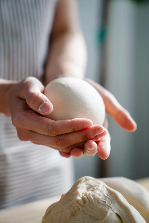 a close up of a person holding an object