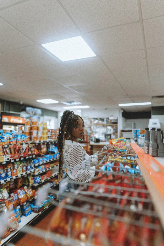 young black woman shopping at grocery store shelves