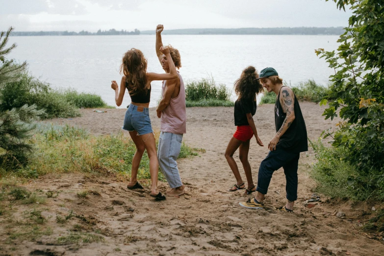 four s are playing in the mud on the beach