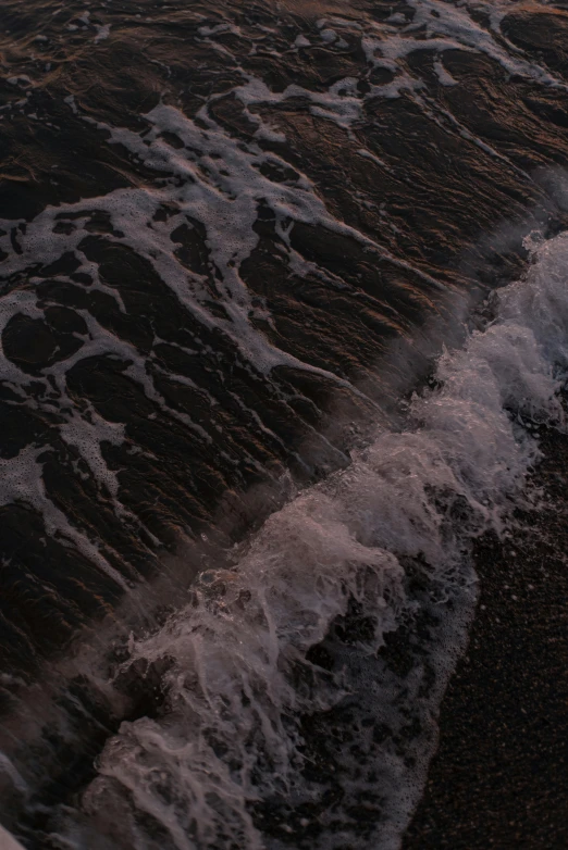 an aerial view of the waves of the beach