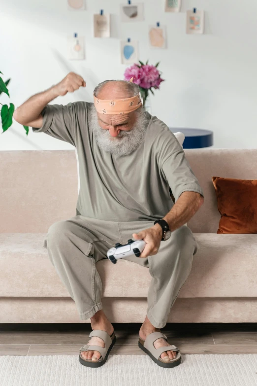 an older man sitting on a couch with a remote