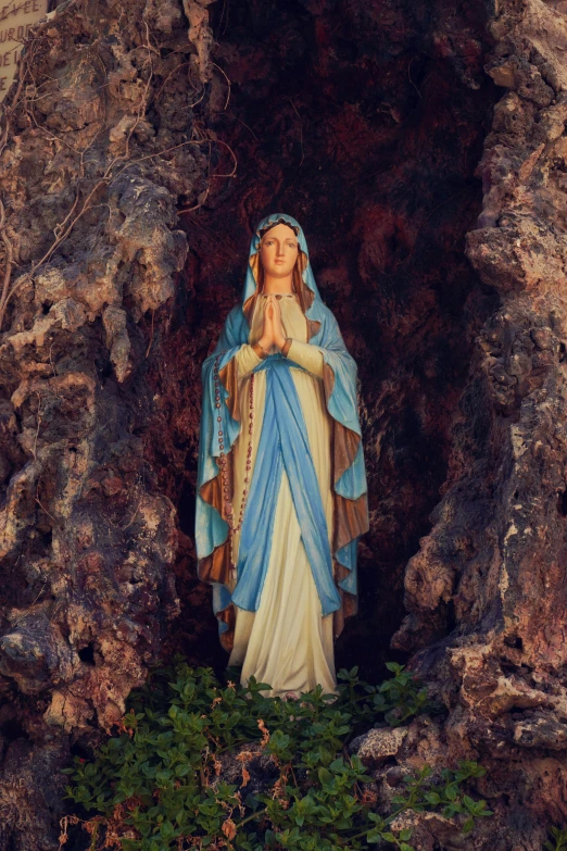 an image of a statue sitting in a cave