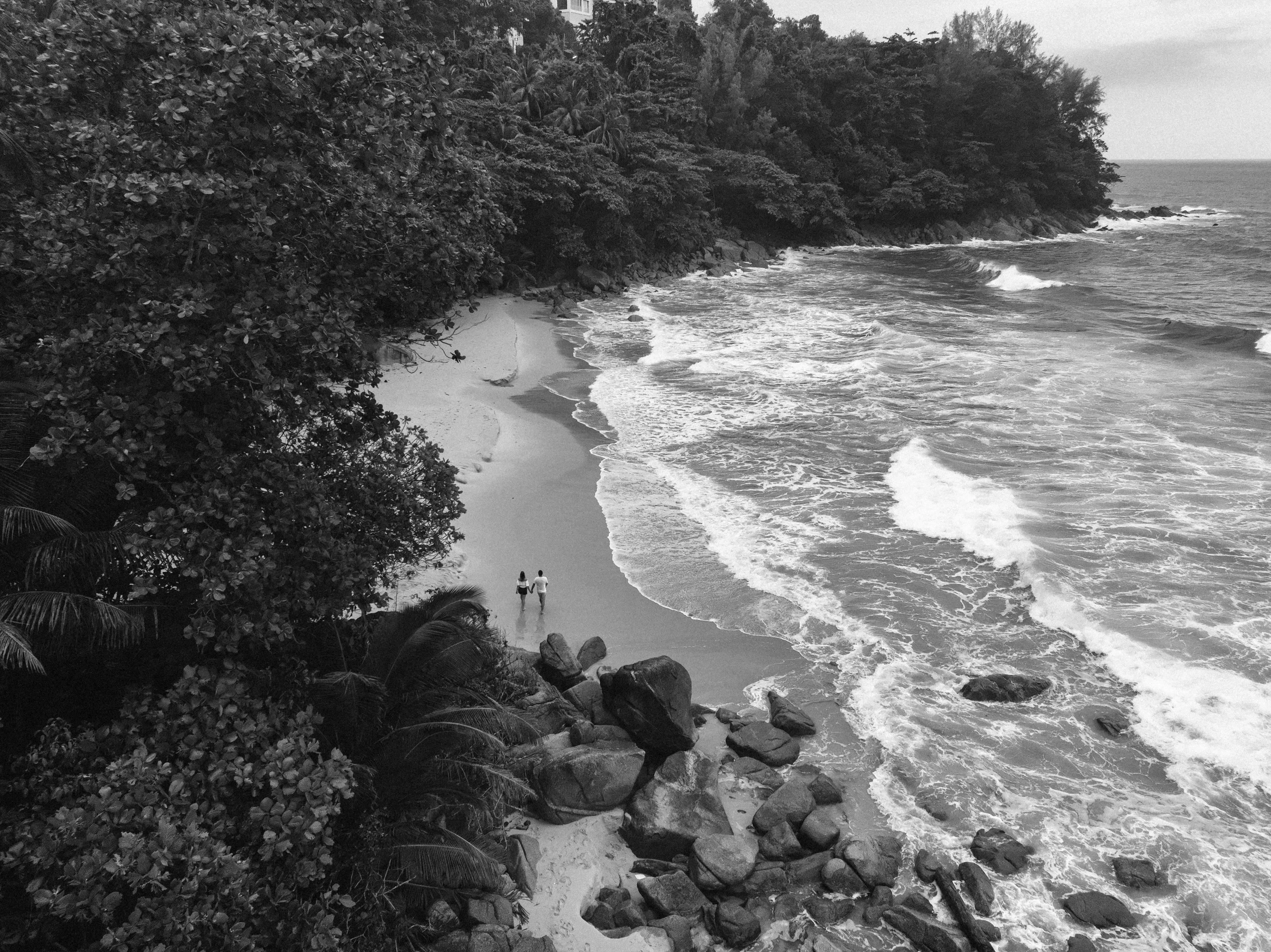 an overview of an ocean shore and rocks along the beach