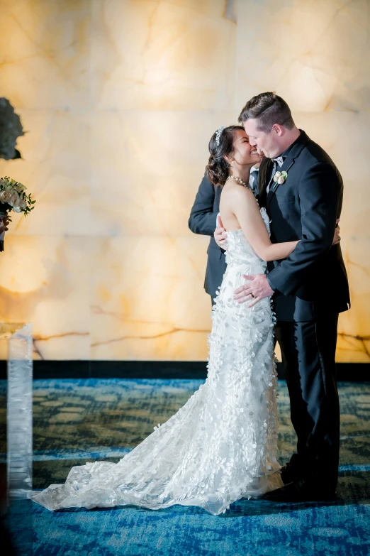 a bride and groom pose together at their wedding