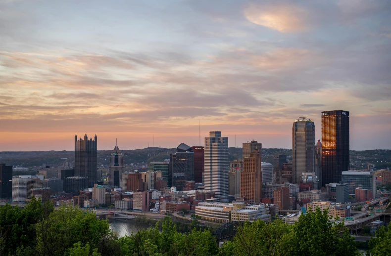 the view from a mountain top of a city with buildings