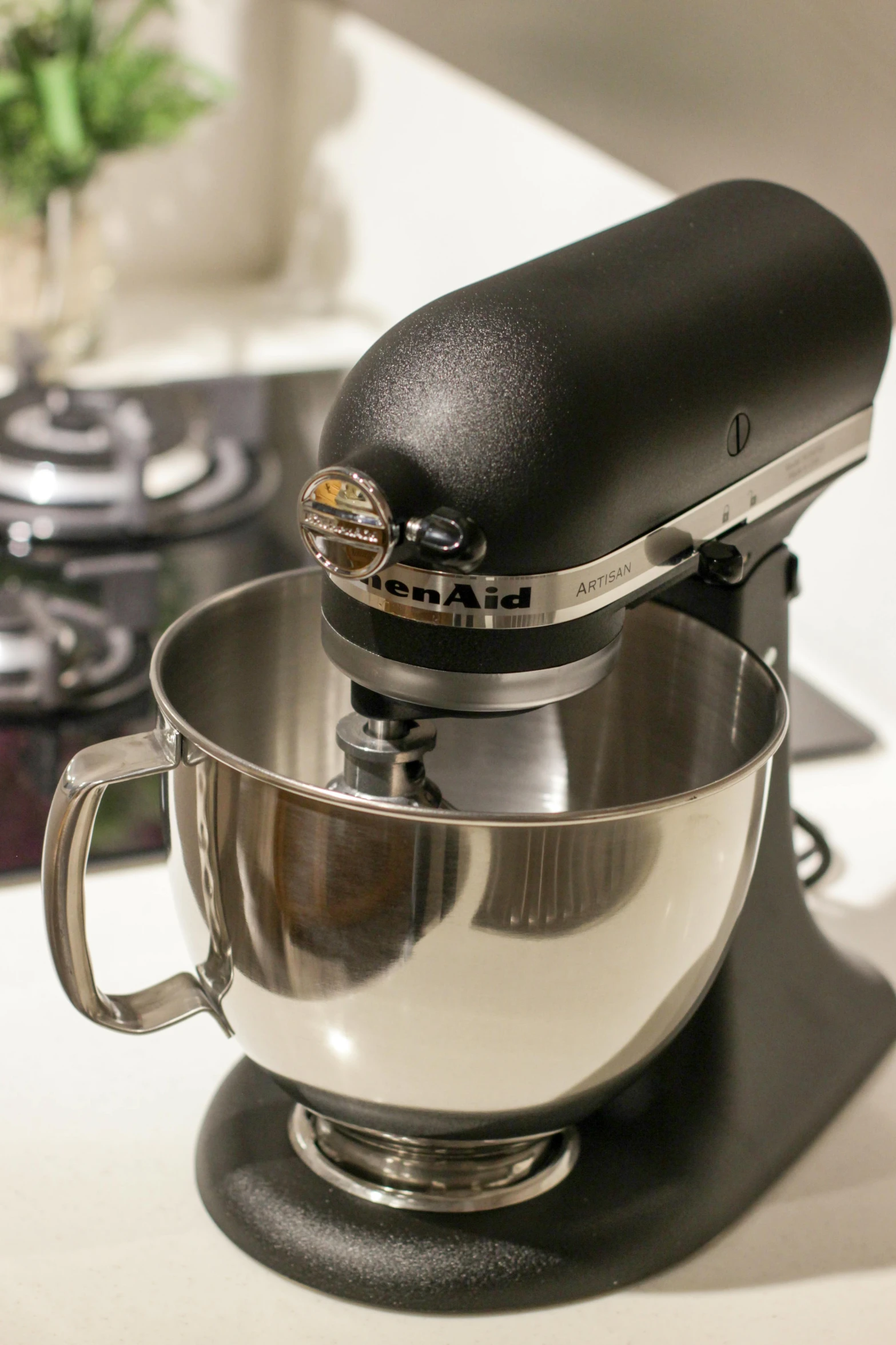 a black and silver stand mixer on a counter