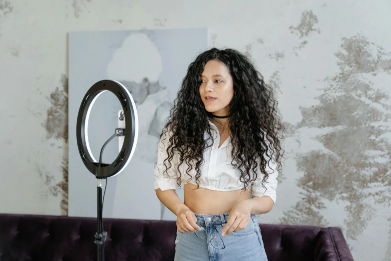 a woman in short shorts standing next to a mirror