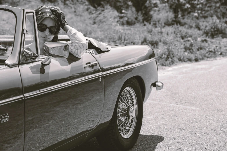 a woman with a hat is riding in a car