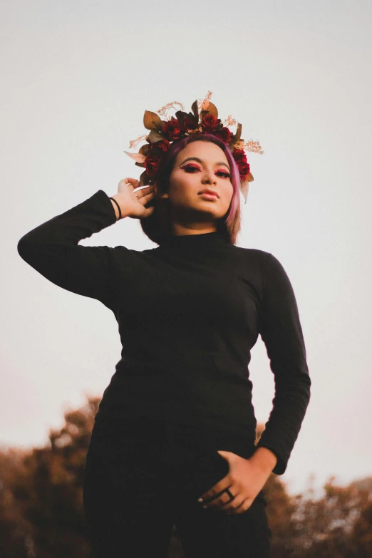 a woman with a crown on her head is posing