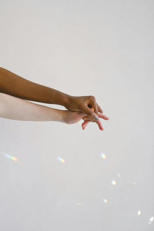 a person holding the ends of his hand above a clear sky