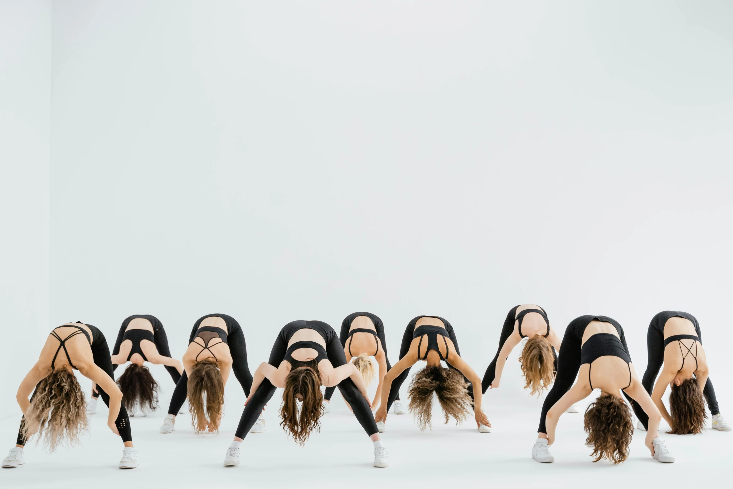 six women wearing all black in the shape of dancers