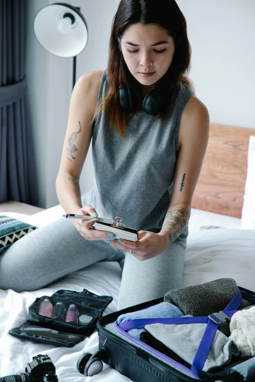 woman in a bed holding some kind of device