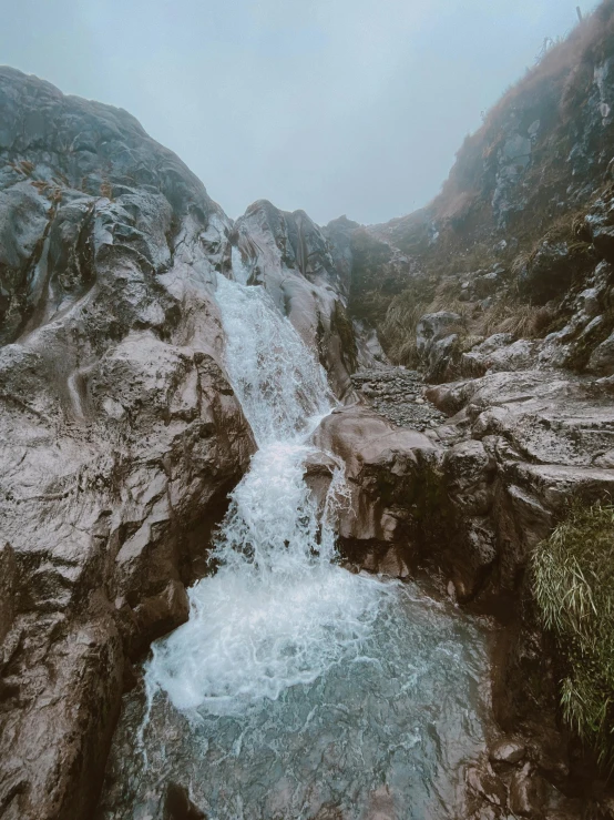 a river surrounded by rock mountains and small stream