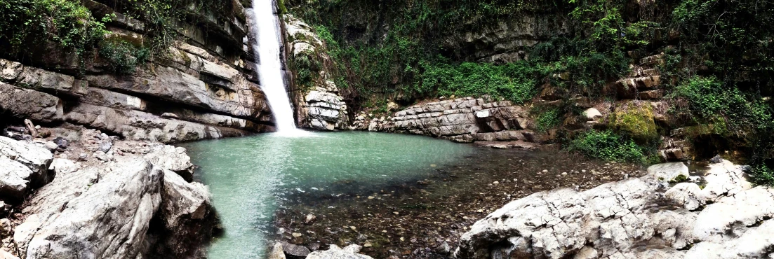 a small pool that is next to a waterfall