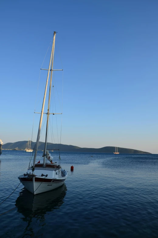 a sailboat sailing on a lake during the day