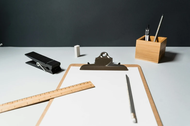 a table with a pen, ruler and various objects