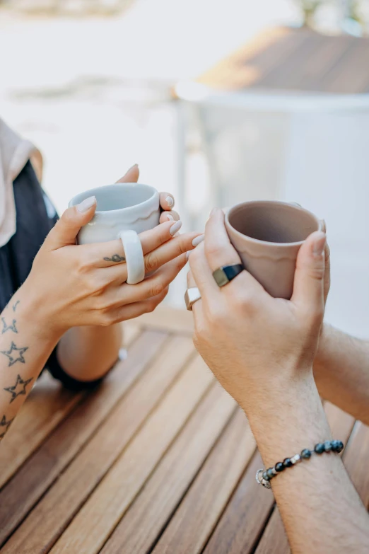 a couple is holding hands while eating