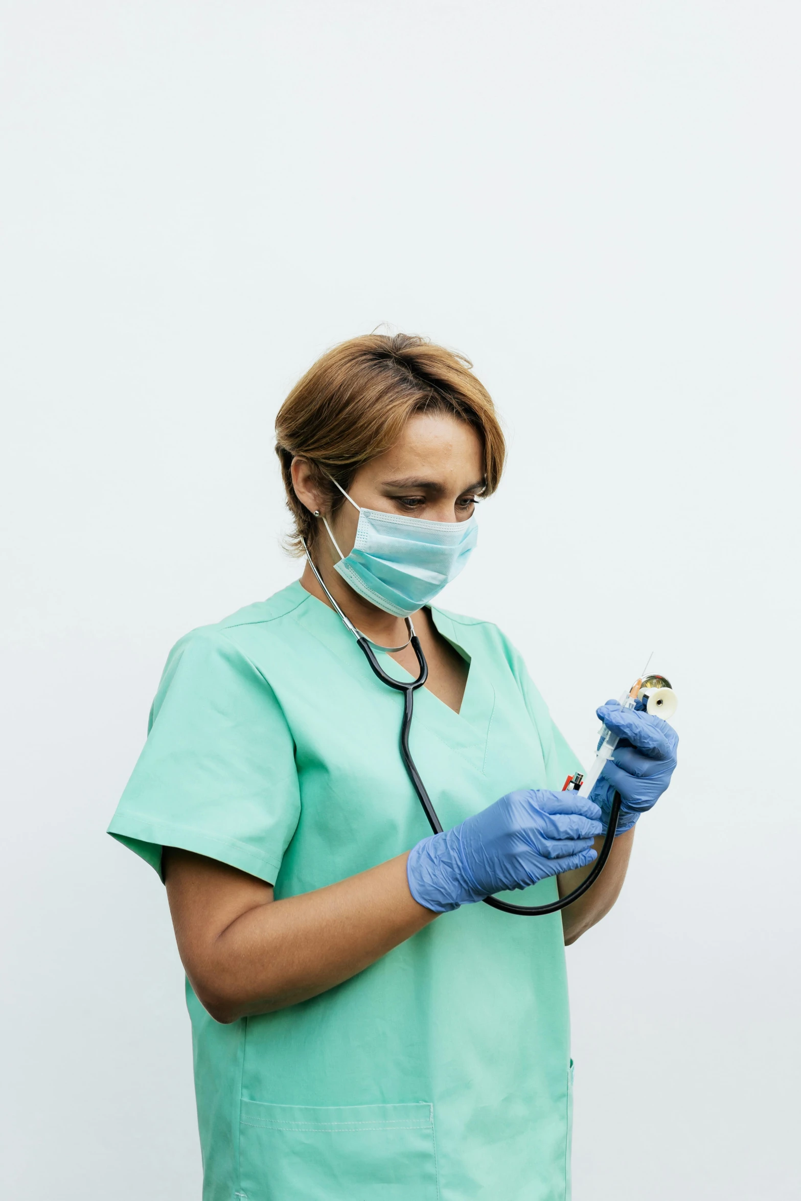 a woman with a mask and gloves looking at soing