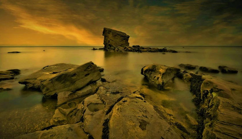 rock formations with water and sky in the background