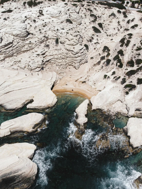 an aerial view of some water and rocks