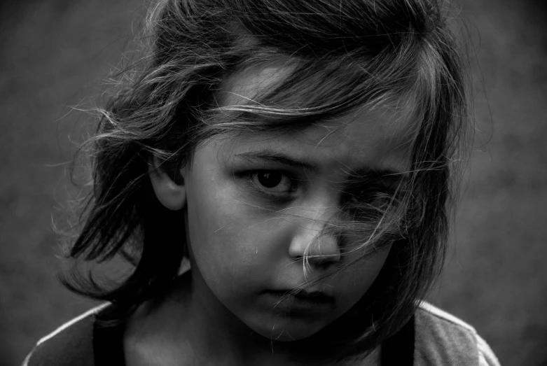 a close up of a child looking directly at the camera