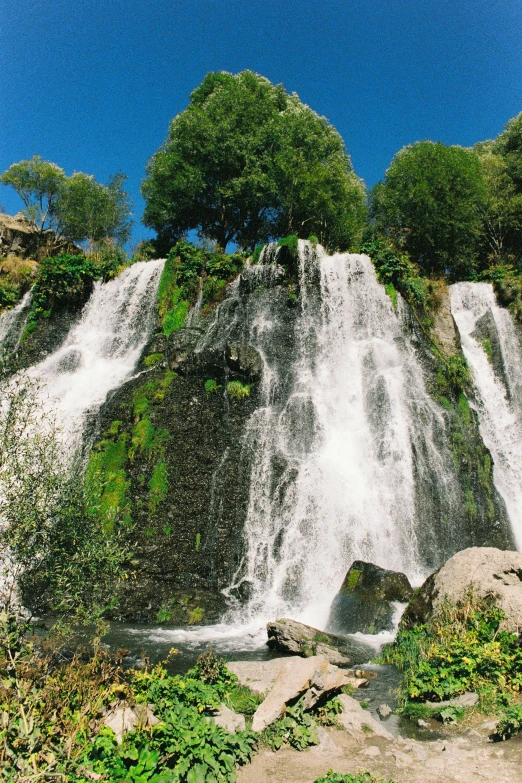 a couple of large water fall on the side of a hill