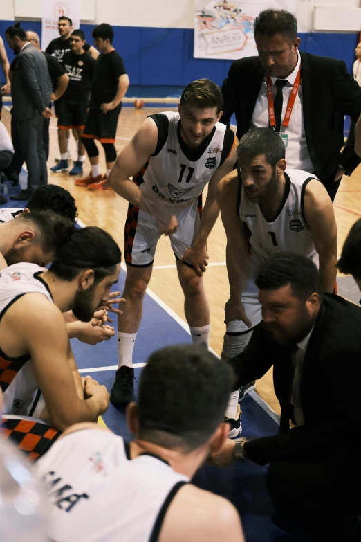 some men in white basketball uniforms on a court