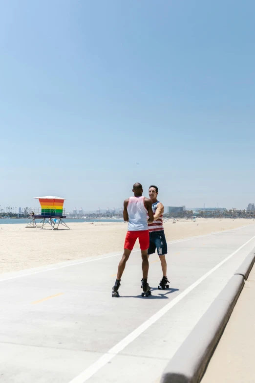 two people standing in the street while riding skateboards