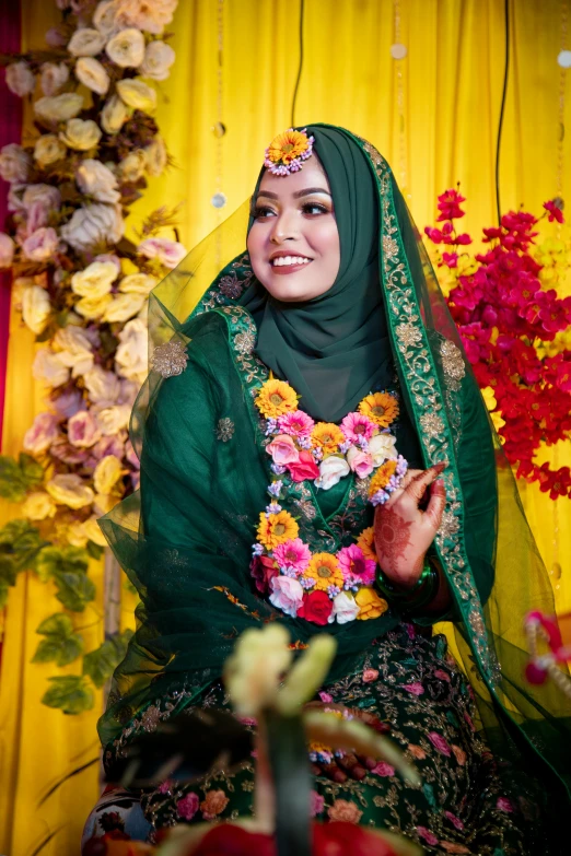 woman sitting in front of a wall with flowers