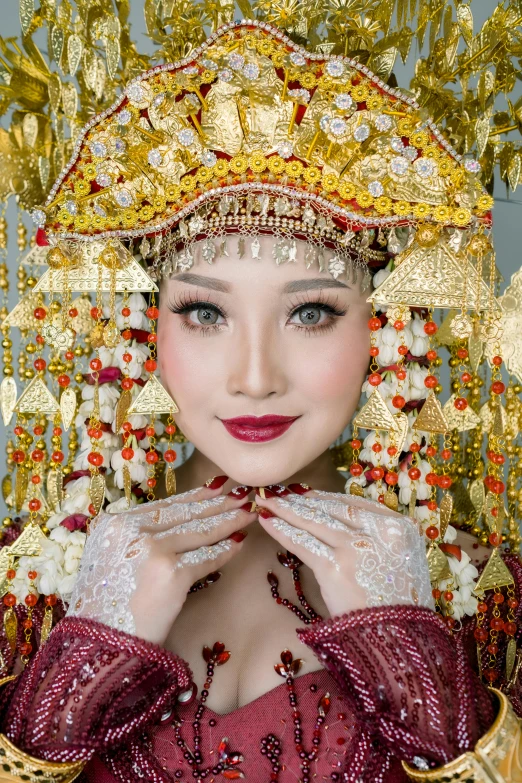 a woman is dressed in elaborate clothing and is posing for the camera