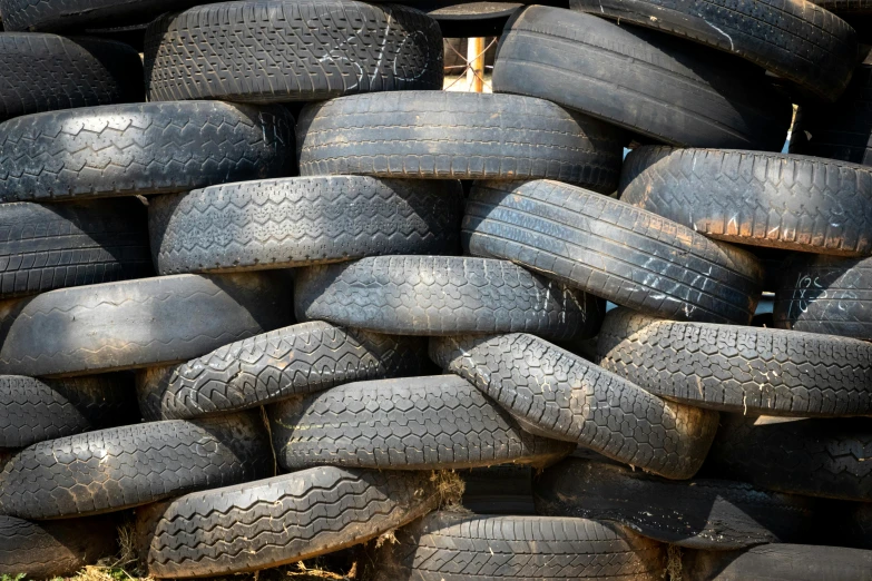 the tires are stacked up for sale on the sidewalk