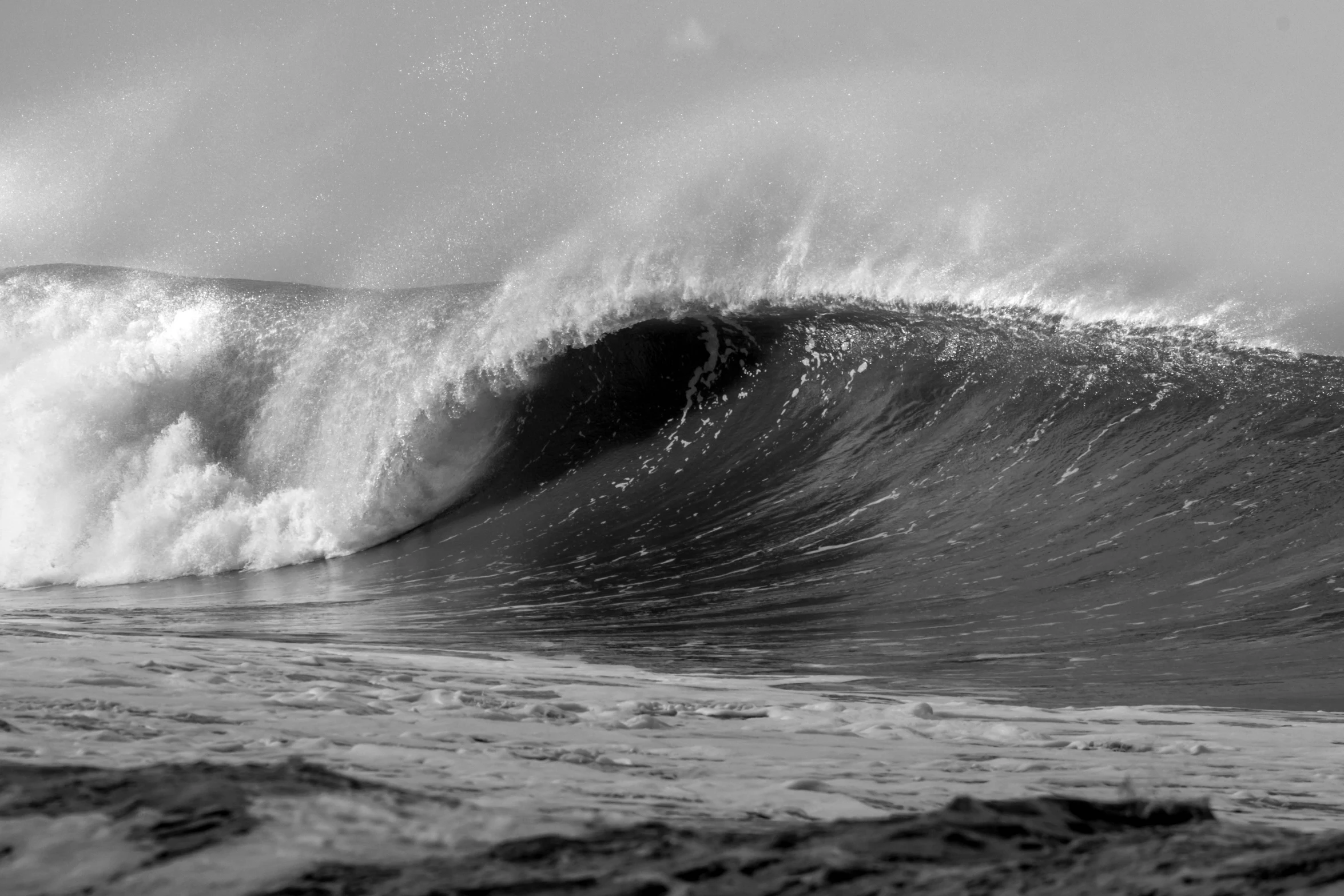 a man surfing in the waves of the ocean