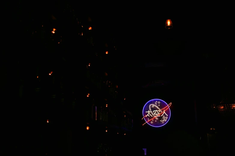 an area with lights and dark background with a neon sign and clock on it