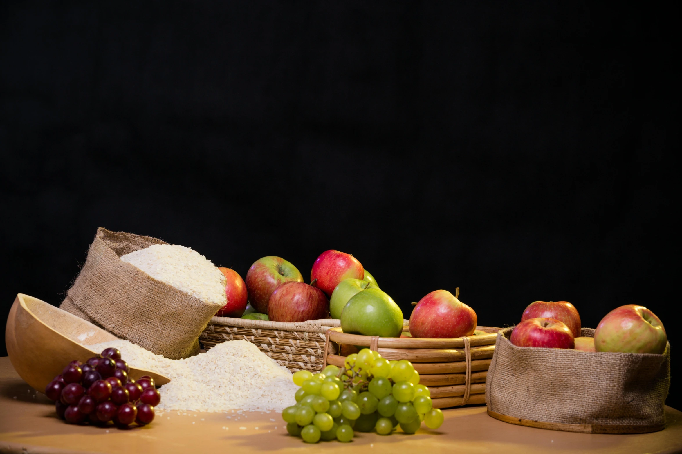 a wooden table topped with bowls filled with apples and gs