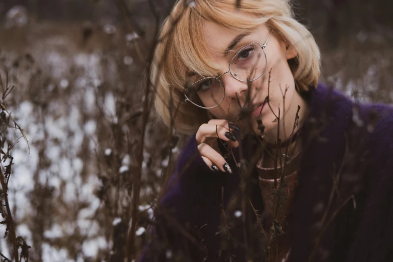 a woman is in the middle of bushes talking on the phone