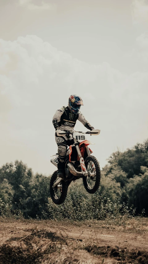 a motorcyclist making an interesting jump with his bike